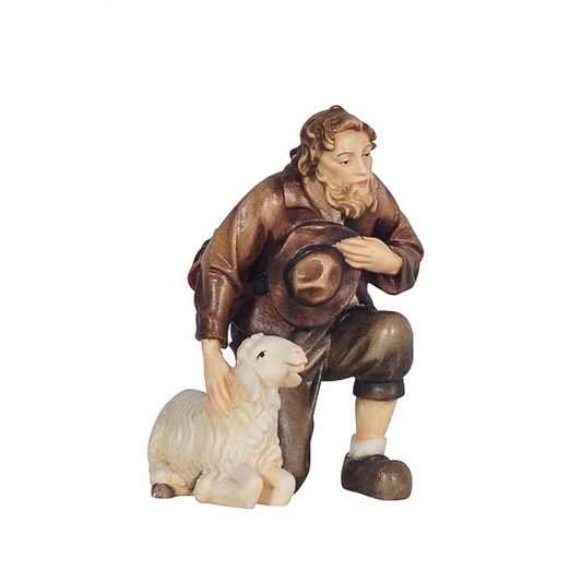 Shepherd kneeling with sheep 